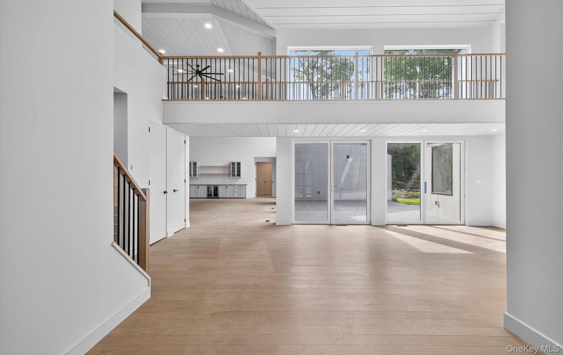 26 Windemere Way Woodbury, NY 11797 - Photo 4 of 40 wooden floor in an empty room with a window