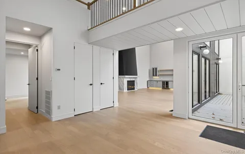 an empty room with a cabinet and mirrors