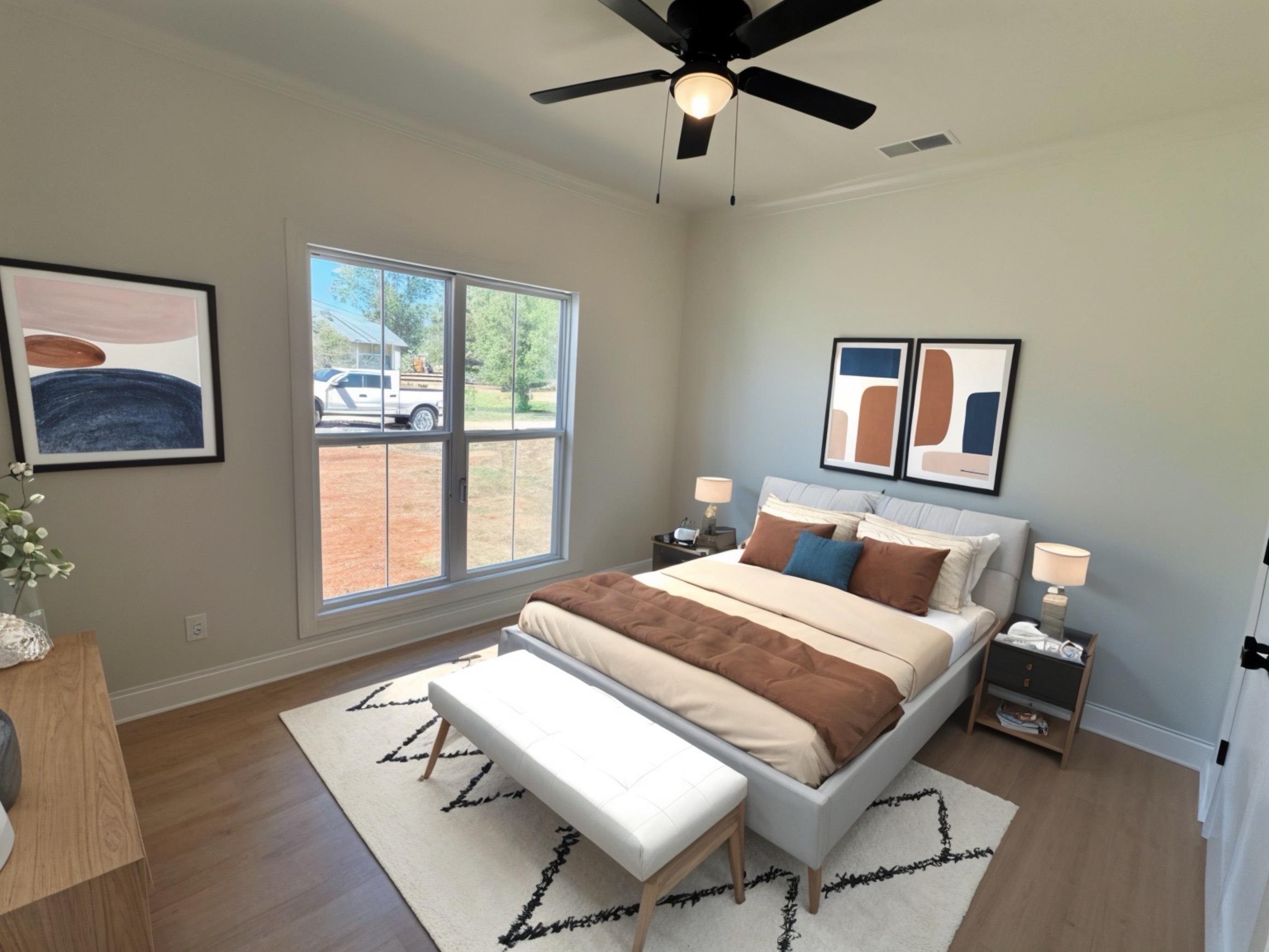 135 Paine Road Savannah, TN 38372 - Photo 5 of 14 a bedroom with a bed and wooden floor