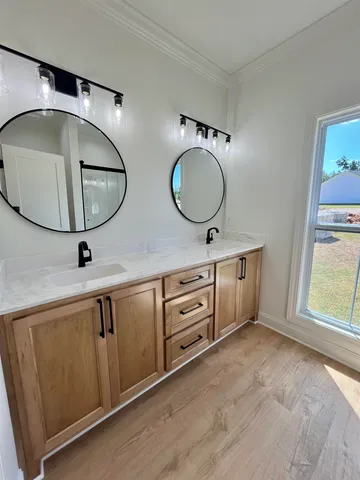 a bathroom with a double vanity sink and a mirror