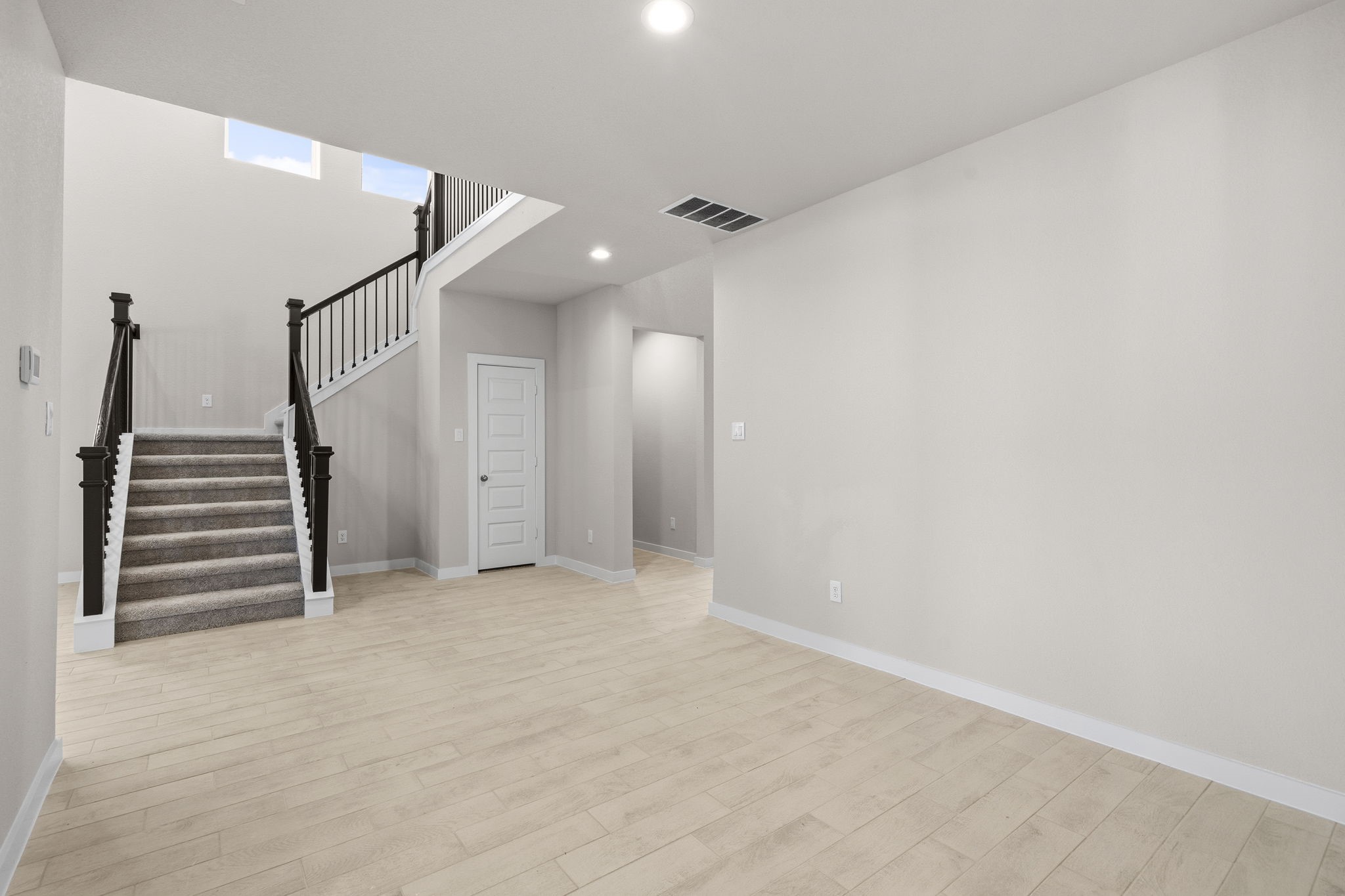 2567 Forest Cedar Lane Conroe, TX 77301 - Photo 11 of 40 a view of an empty room with stairs and a ceiling fan