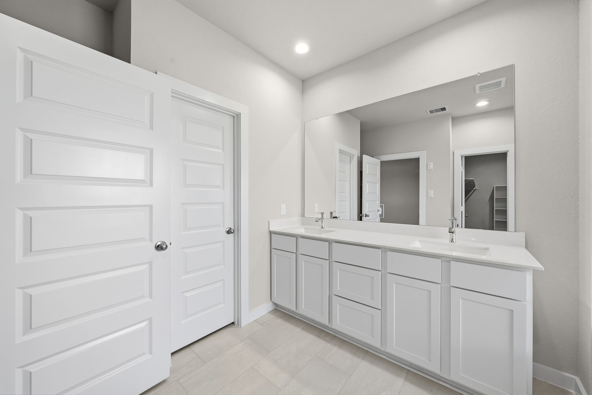 2567 Forest Cedar Lane Conroe, TX 77301 - Photo 19 of 40 a bathroom with a double vanity sink and mirror