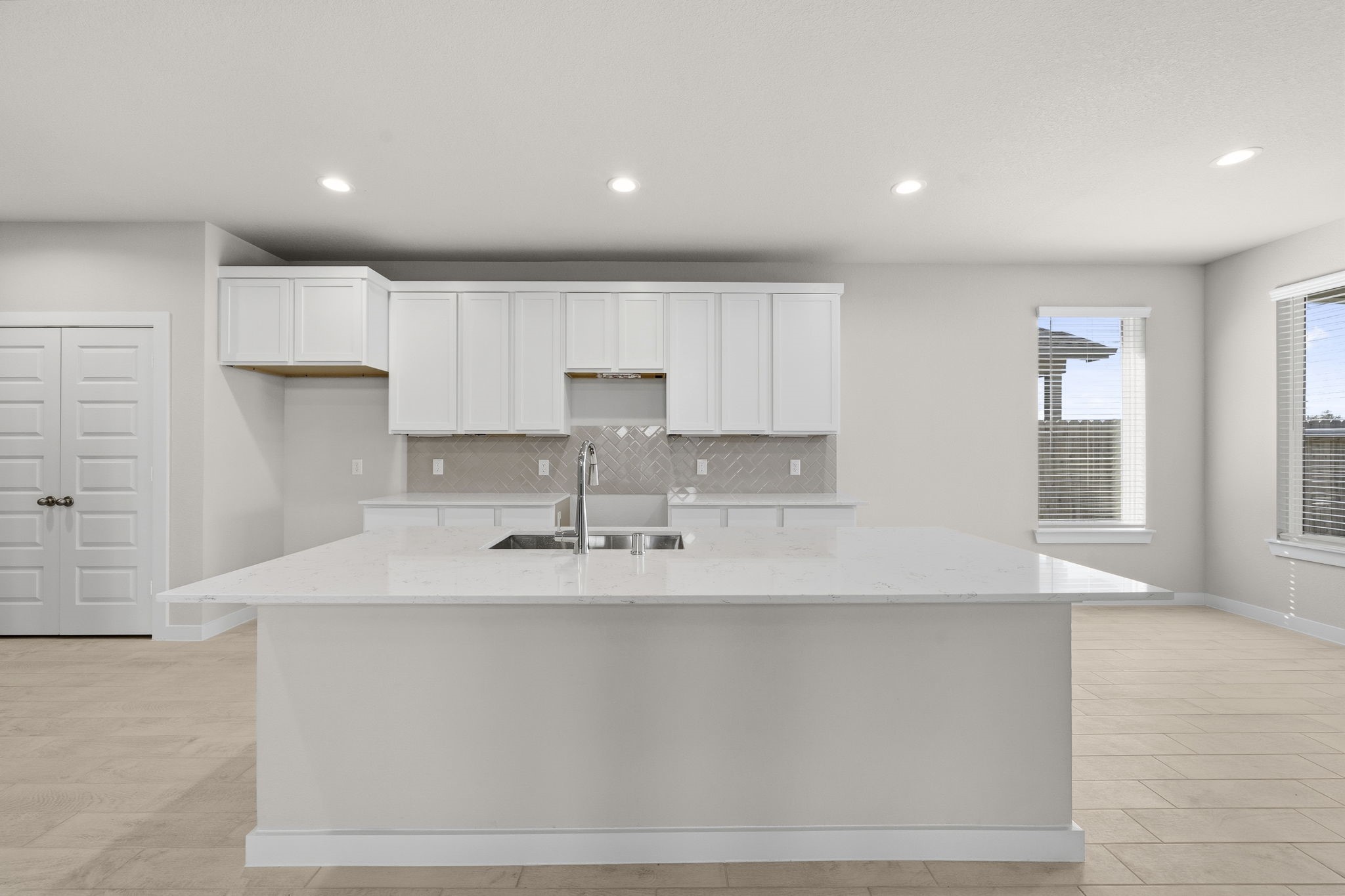 2567 Forest Cedar Lane Conroe, TX 77301 - Photo 2 of 40 a kitchen with kitchen island granite countertop a sink a stove a refrigerator and white cabinets