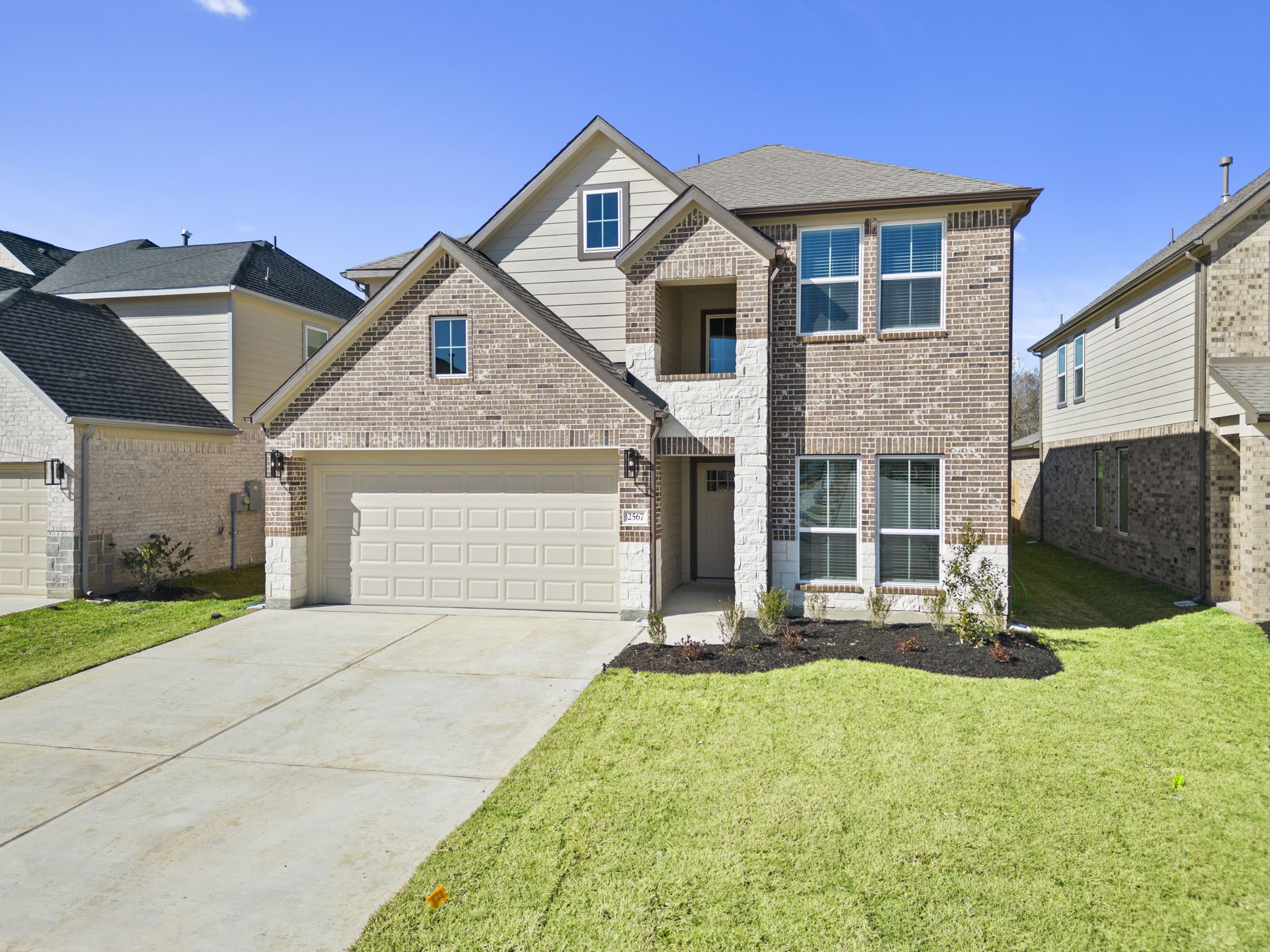2567 Forest Cedar Lane Conroe, TX 77301 - Photo 36 of 40 a front view of a house with a yard and garage