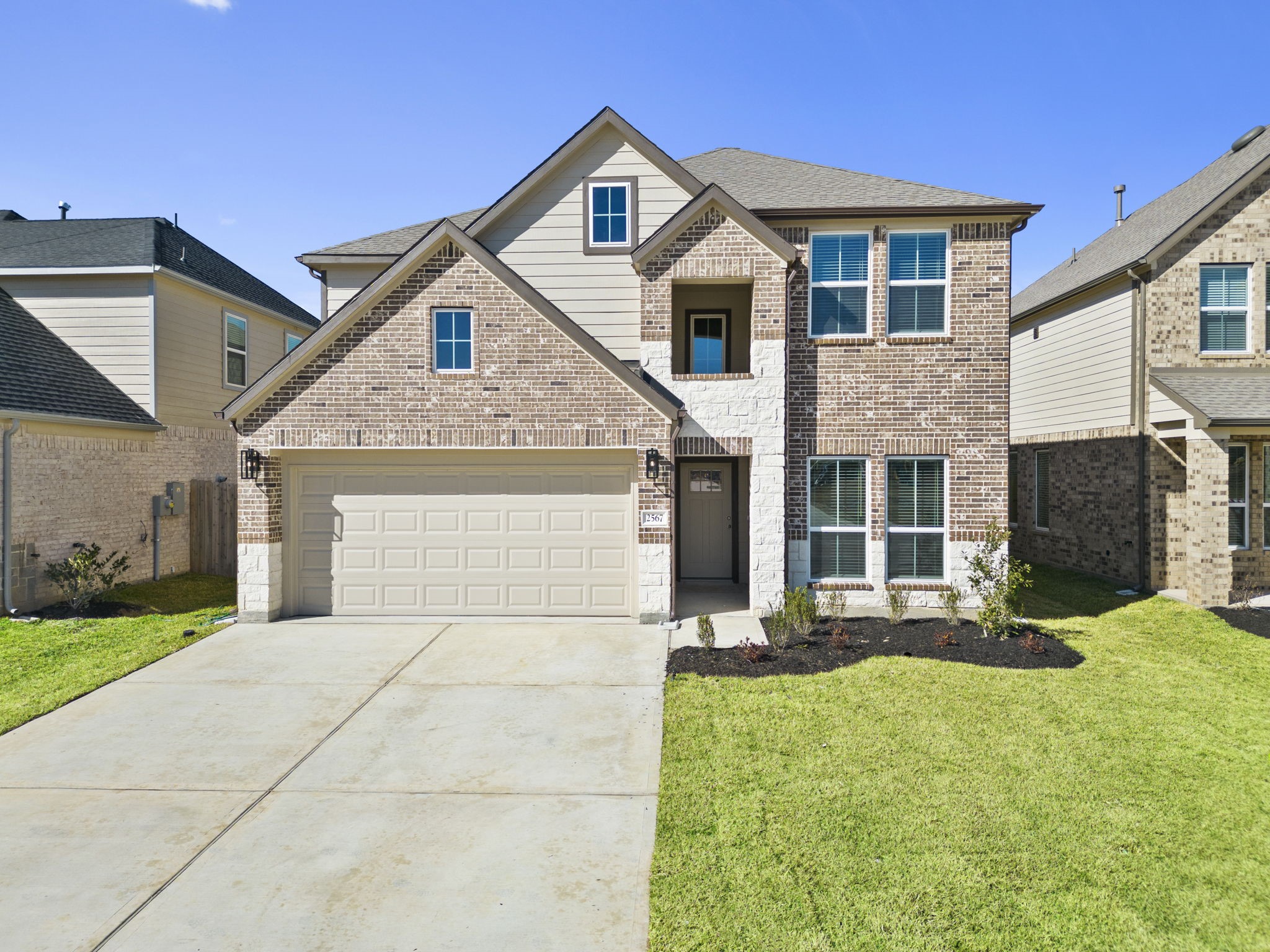 2567 Forest Cedar Lane Conroe, TX 77301 - Photo 37 of 40 a front view of a house with a yard and garage