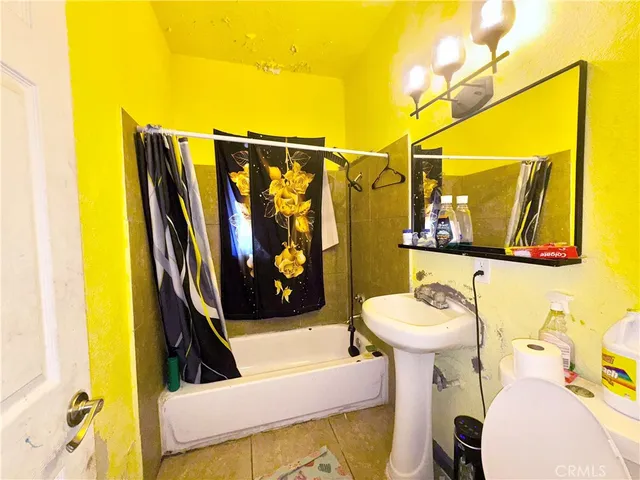 a bathroom with a sink toilet and mirror