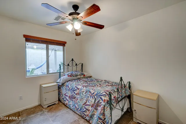 a bedroom with a bed and a window