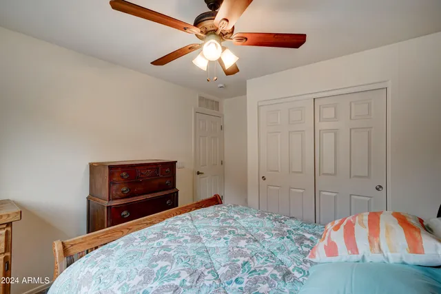 a bedroom with a bed and a dresser