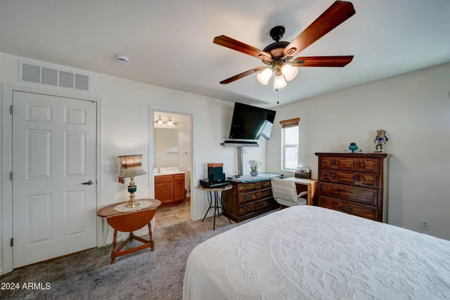 a bedroom with a bed dresser and a window