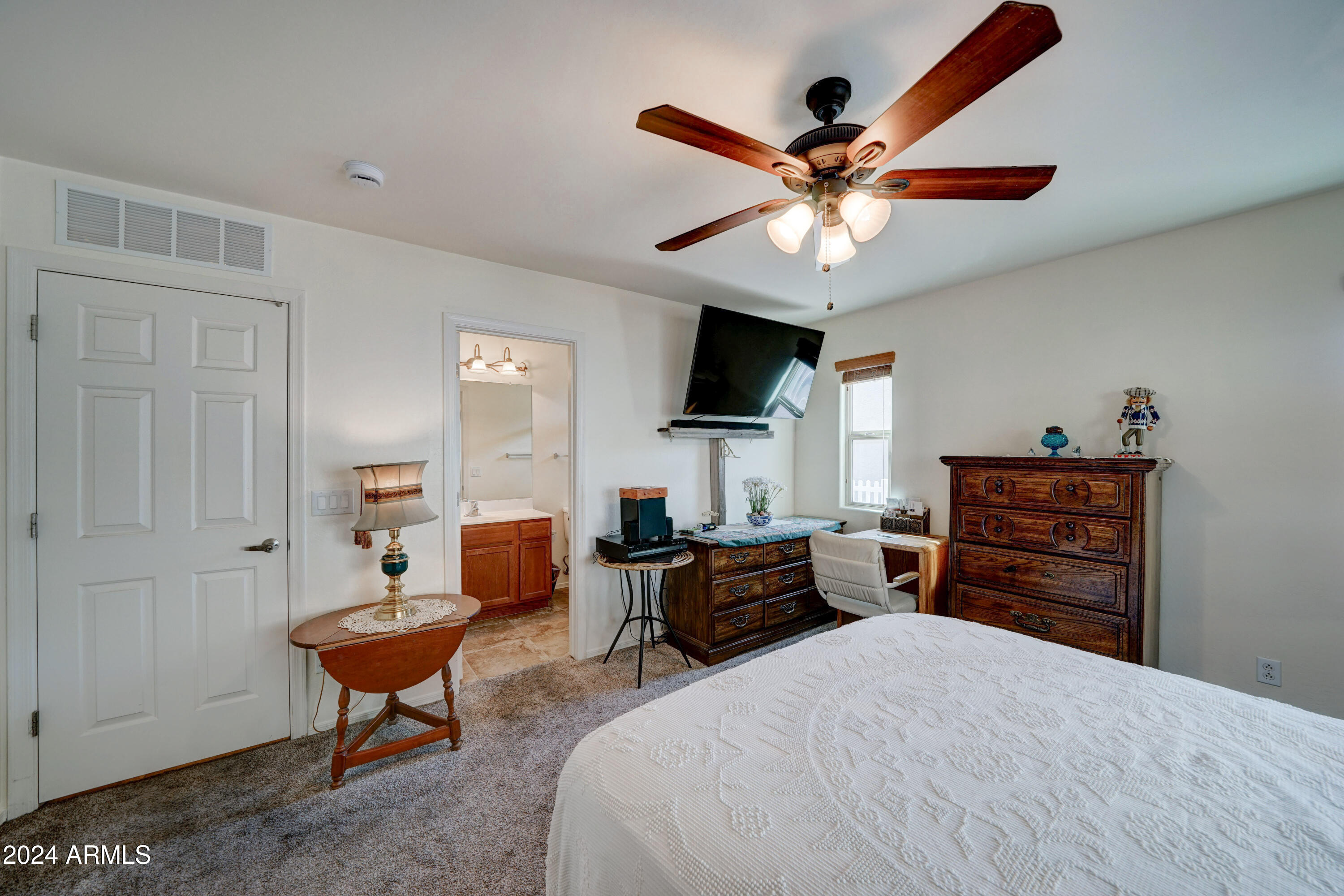 2101 South Meridian Road, Unit 157 Apache Junction, AZ 85120 - Photo 17 of 51 a bedroom with a bed dresser and a window