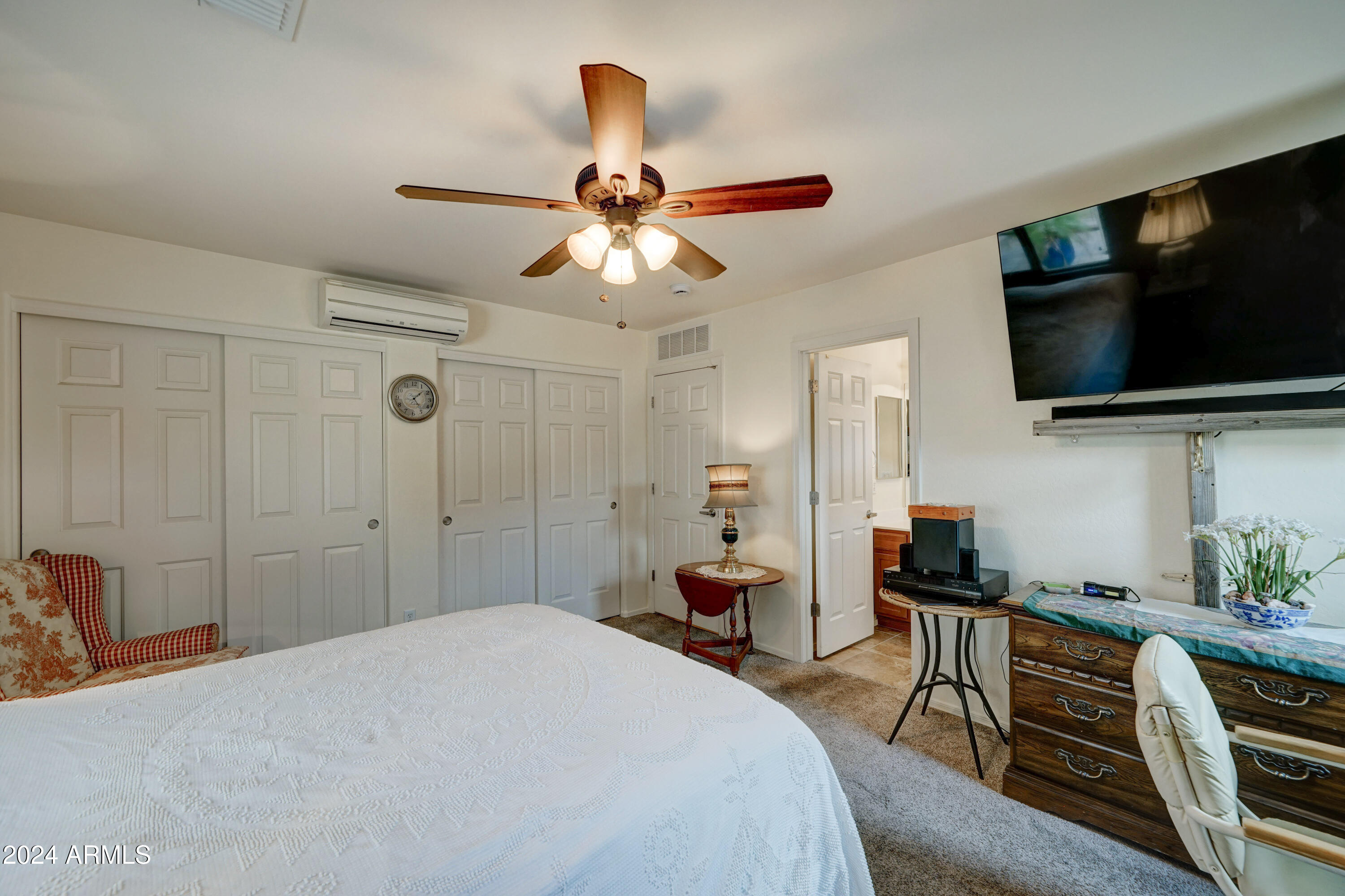 2101 South Meridian Road, Unit 157 Apache Junction, AZ 85120 - Photo 18 of 51 a bedroom with a bed and a flat screen tv