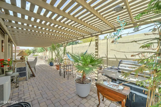 a view of a porch with chairs and potted plants