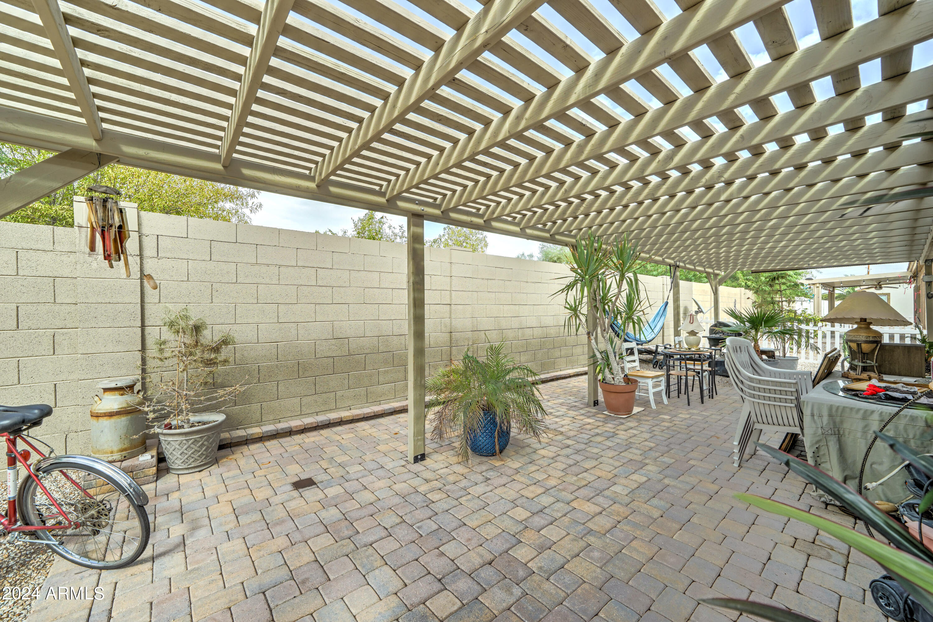 2101 South Meridian Road, Unit 157 Apache Junction, AZ 85120 - Photo 25 of 51 a view of a patio with table and chairs and potted plants