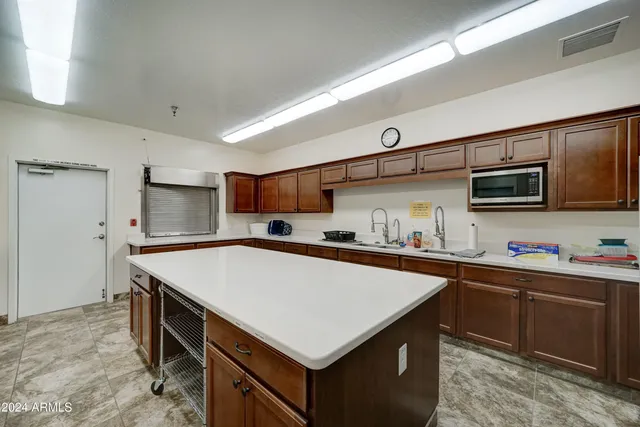 a kitchen with stainless steel appliances granite countertop a sink counter space and cabinets