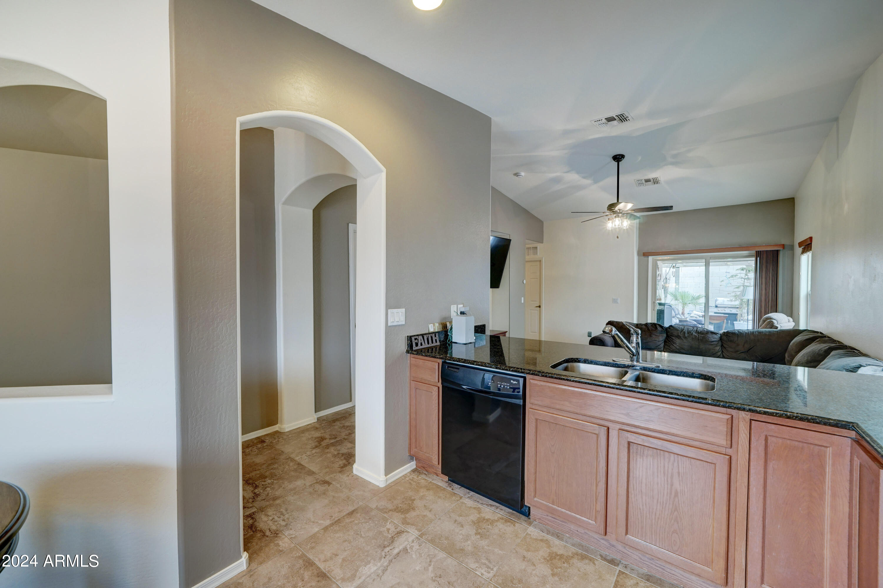 2101 South Meridian Road, Unit 157 Apache Junction, AZ 85120 - Photo 6 of 51 a kitchen with granite countertop a sink and cabinets