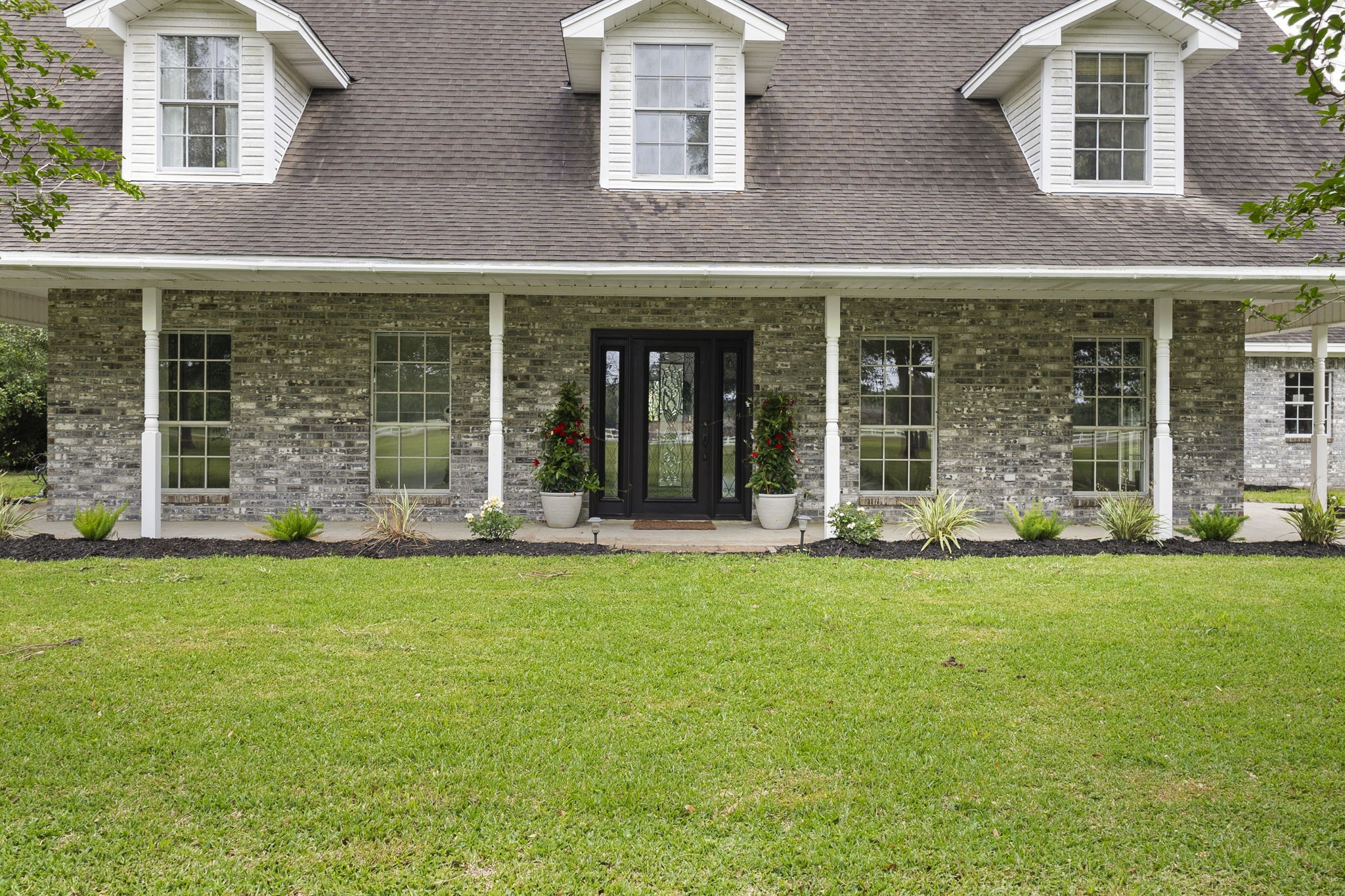 16421 Westbury Road Beaumont, TX 77713 - Photo 5 of 29 front view of a brick house with a yard