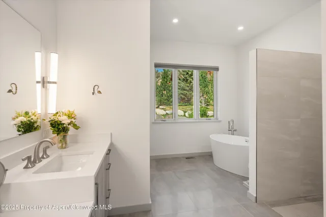 a utility room with sink dryer and washer