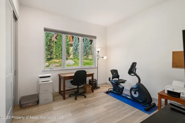 a wooden bench sitting in front of a building