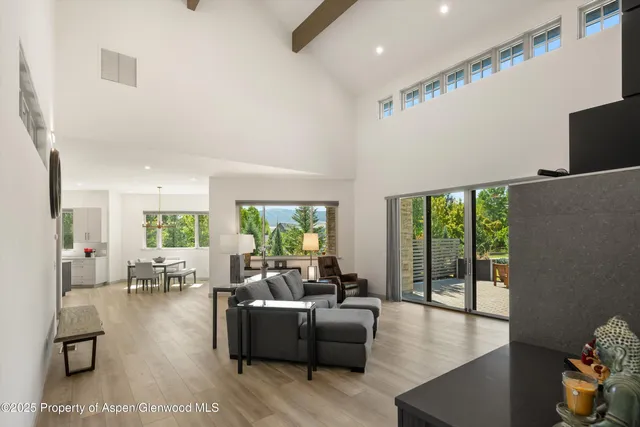 a living room with hardwood floor and a large window