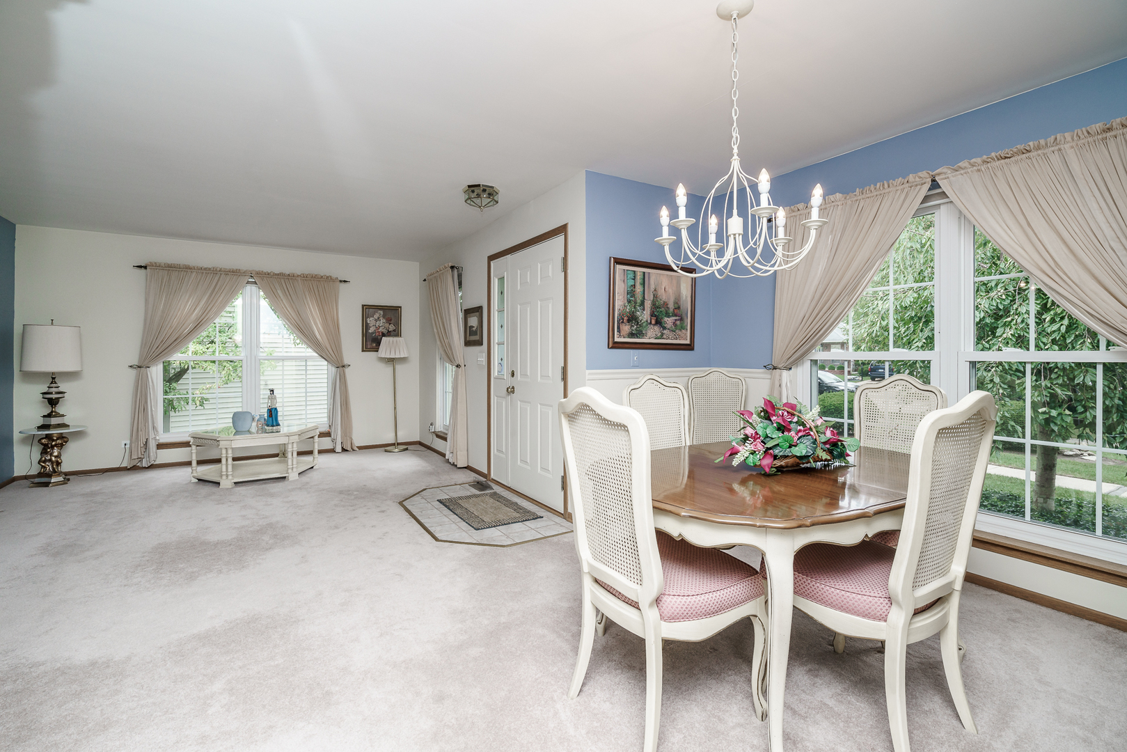 309 Spring Valley Way Round Lake, IL 60073 - Photo 3 of 26 a dining room with furniture a chandelier and window