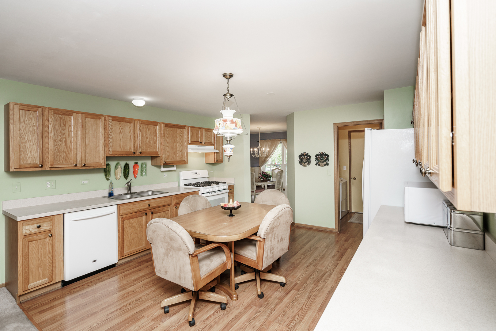 309 Spring Valley Way Round Lake, IL 60073 - Photo 9 of 26 a kitchen with a table and chairs in it