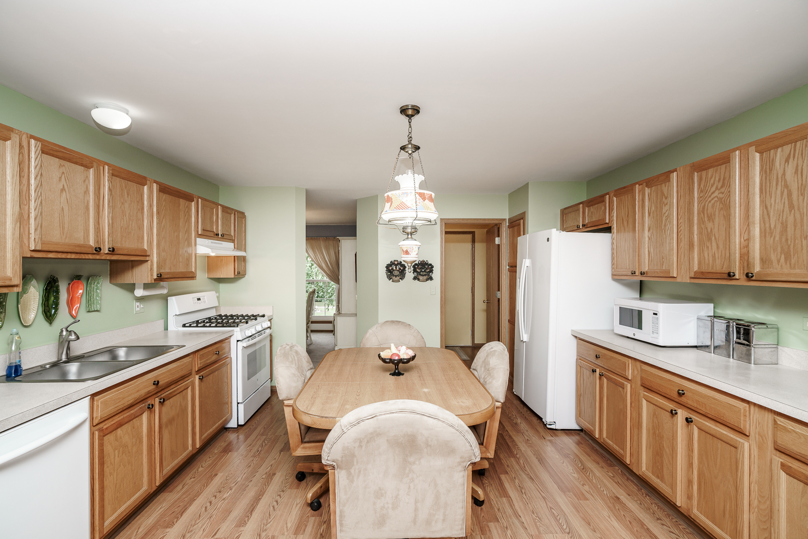 309 Spring Valley Way Round Lake, IL 60073 - Photo 10 of 26 a kitchen with sink cabinets and wooden floor