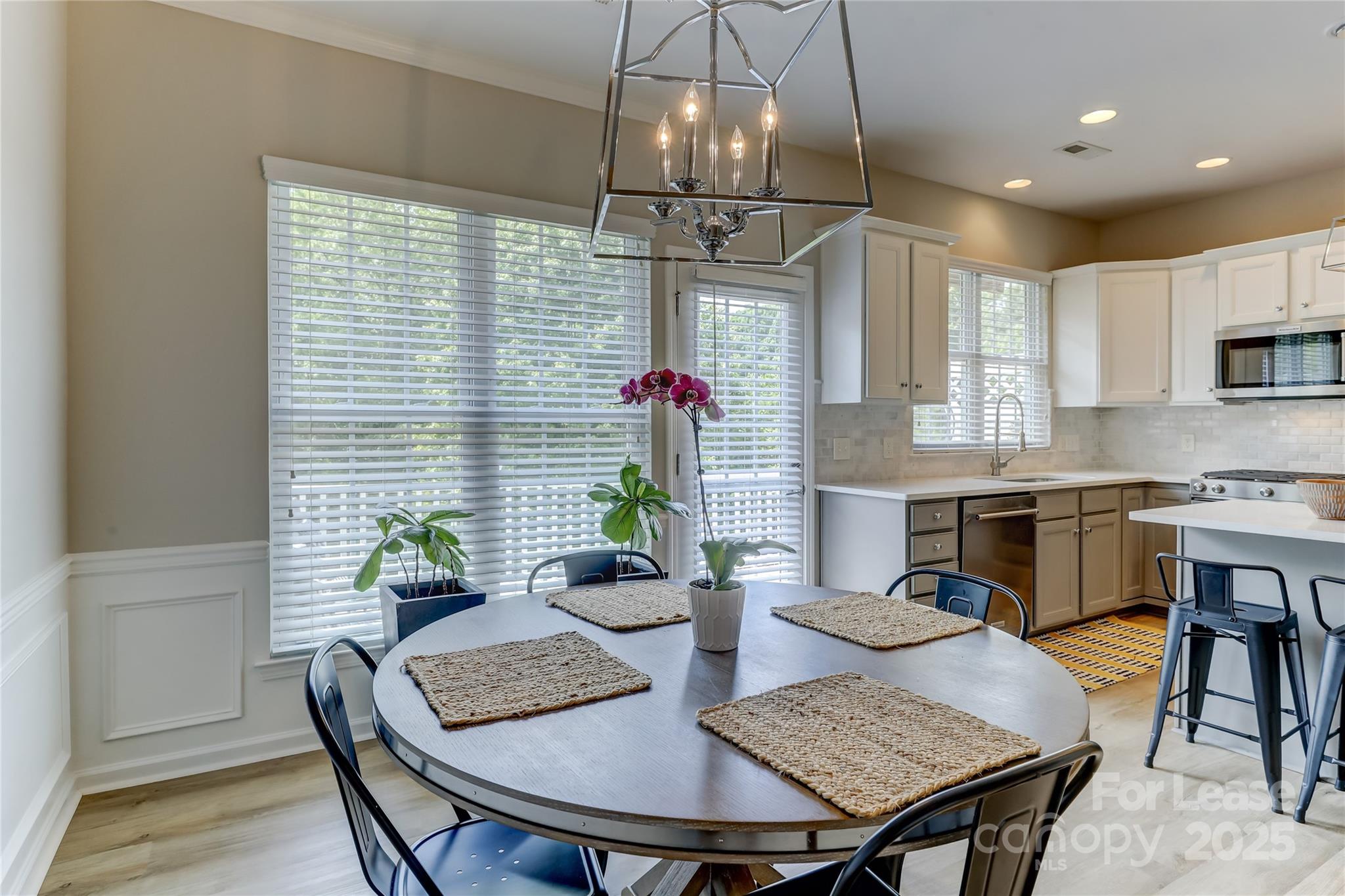 1132 Drayton Court Fort Mill, SC 29708 - Photo 12 of 48 a view of a dining room with furniture a chandelier and wooden floor