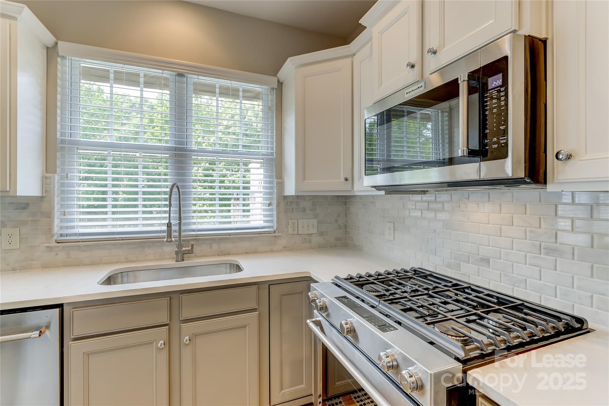 1132 Drayton Court Fort Mill, SC 29708 - Photo 19 of 48 a kitchen with wooden cabinets and a stove top oven