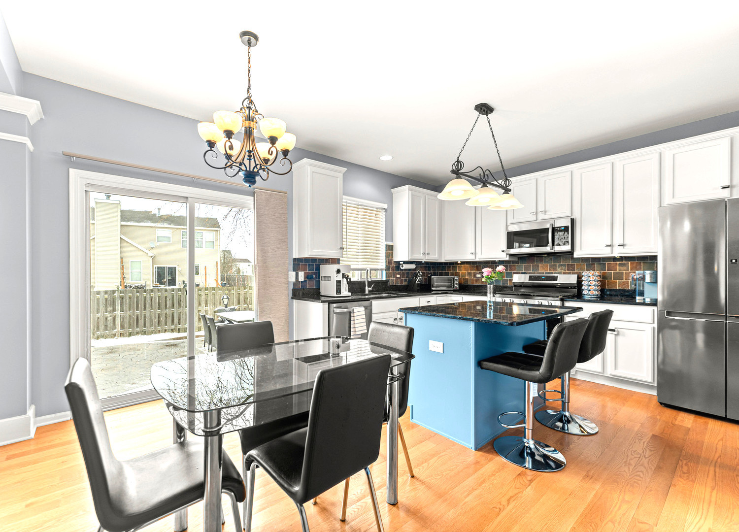 7 Pampas Court Bolingbrook, IL 60490 - Photo 10 of 39 a kitchen with stainless steel appliances granite countertop a stove a refrigerator a kitchen island a dining table and chairs