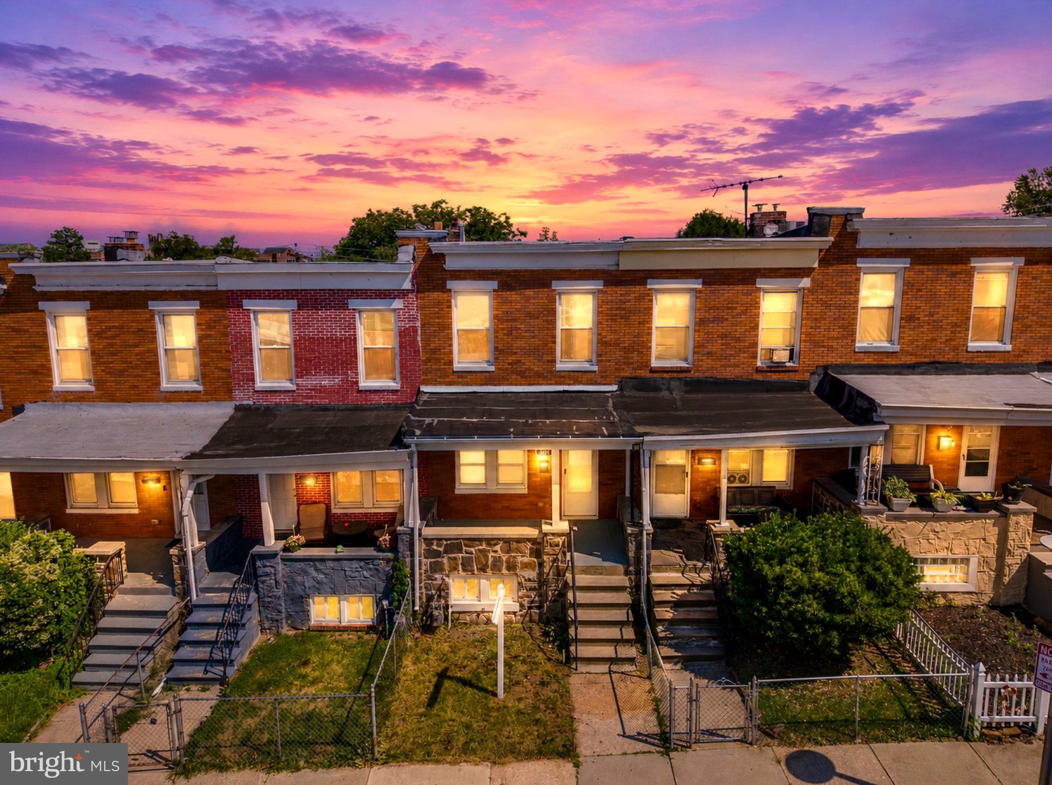 145 North Monastery Avenue Baltimore, MD 21229 - Photo 39 of 45 Charming homes under a vibrant sunset.