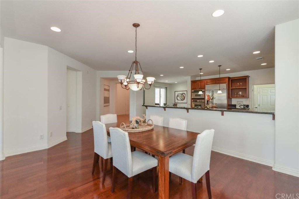 17 Stonegate Irvine, CA 92602 - Photo 15 of 72 a view of a dining room and livingroom with furniture wooden floor a chandelier