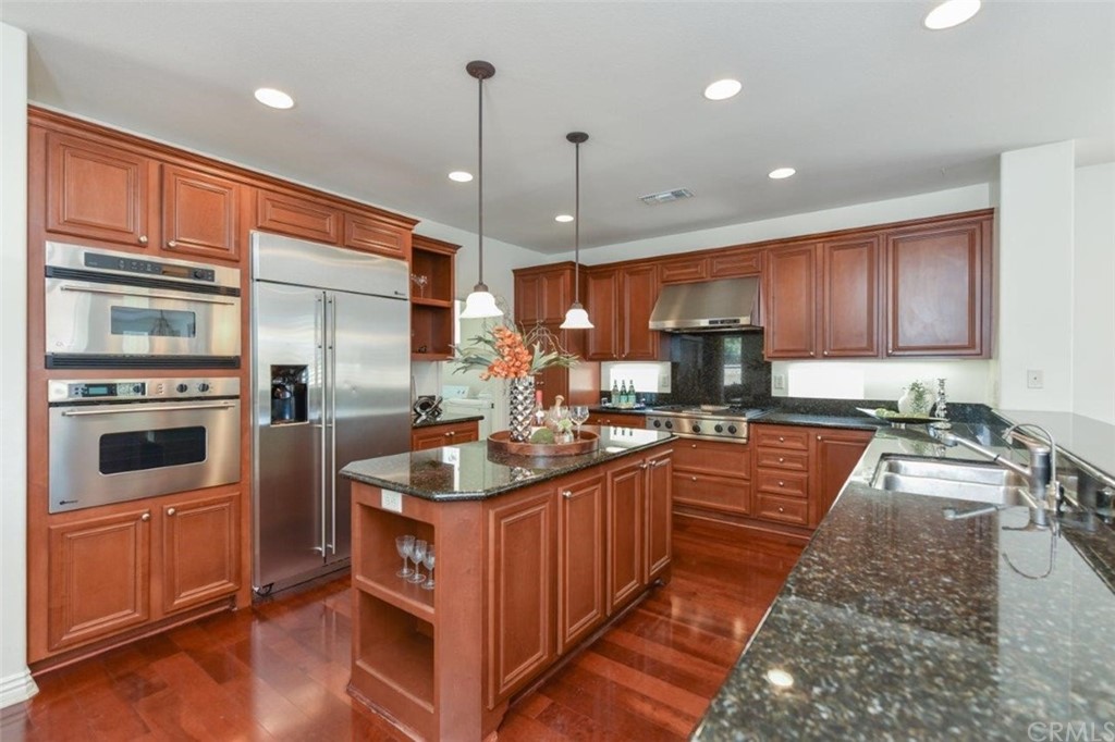 17 Stonegate Irvine, CA 92602 - Photo 19 of 72 a kitchen with stainless steel appliances granite countertop a sink a stove and a refrigerator