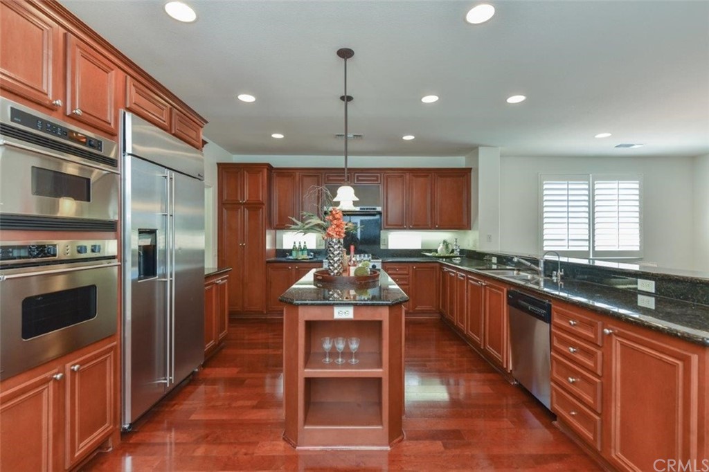 17 Stonegate Irvine, CA 92602 - Photo 20 of 72 a kitchen with stainless steel appliances granite countertop a stove and a refrigerator