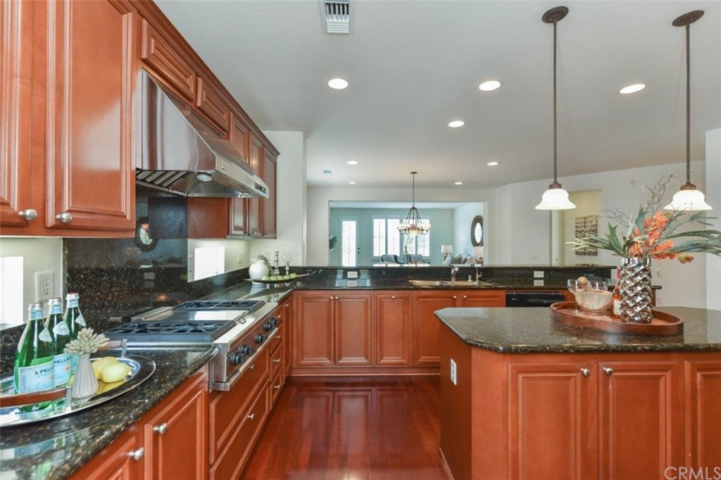 17 Stonegate Irvine, CA 92602 - Photo 23 of 72 a kitchen with granite countertop a sink stove and cabinets