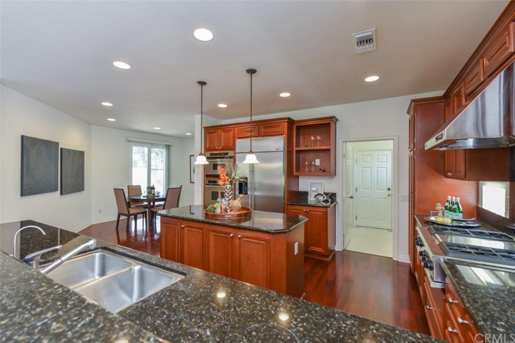 17 Stonegate Irvine, CA 92602 - Photo 26 of 72 a kitchen with stainless steel appliances granite countertop a sink a stove and a refrigerator