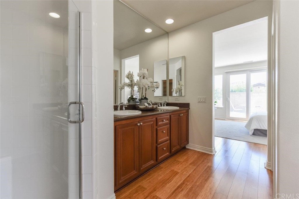 17 Stonegate Irvine, CA 92602 - Photo 45 of 72 a bathroom with a glass door shower a sink and a mirror