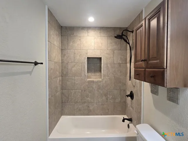 a bathroom with a shower and a tub