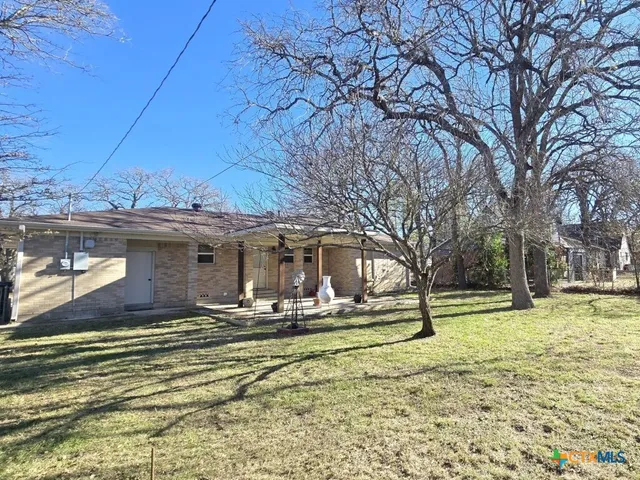 a view of a house with a yard covered with snow