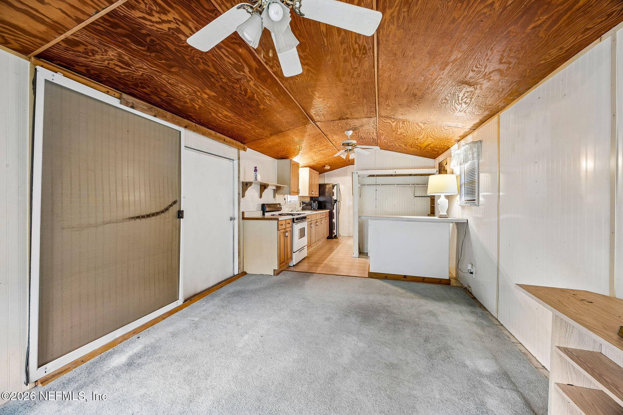 15690 Sears Road Jacksonville, FL 32218 - Photo 15 of 27 a view of a refrigerator in kitchen and wooden floor