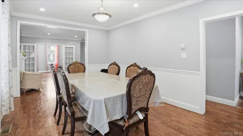 a bed sitting in a bedroom next to a bathroom with wooden floor