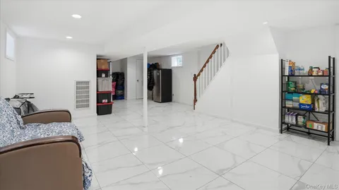 a view of front door with chair and a mirror