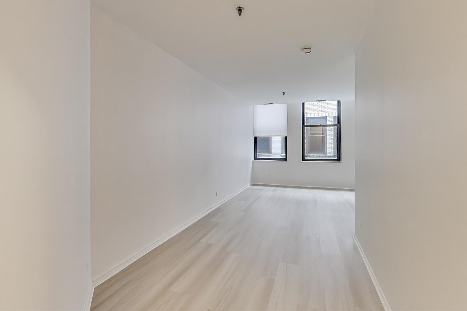 780 South Federal Street, Unit 903 Chicago, IL 60605 - Photo 17 of 31 a view of empty room with wooden floor and fan
