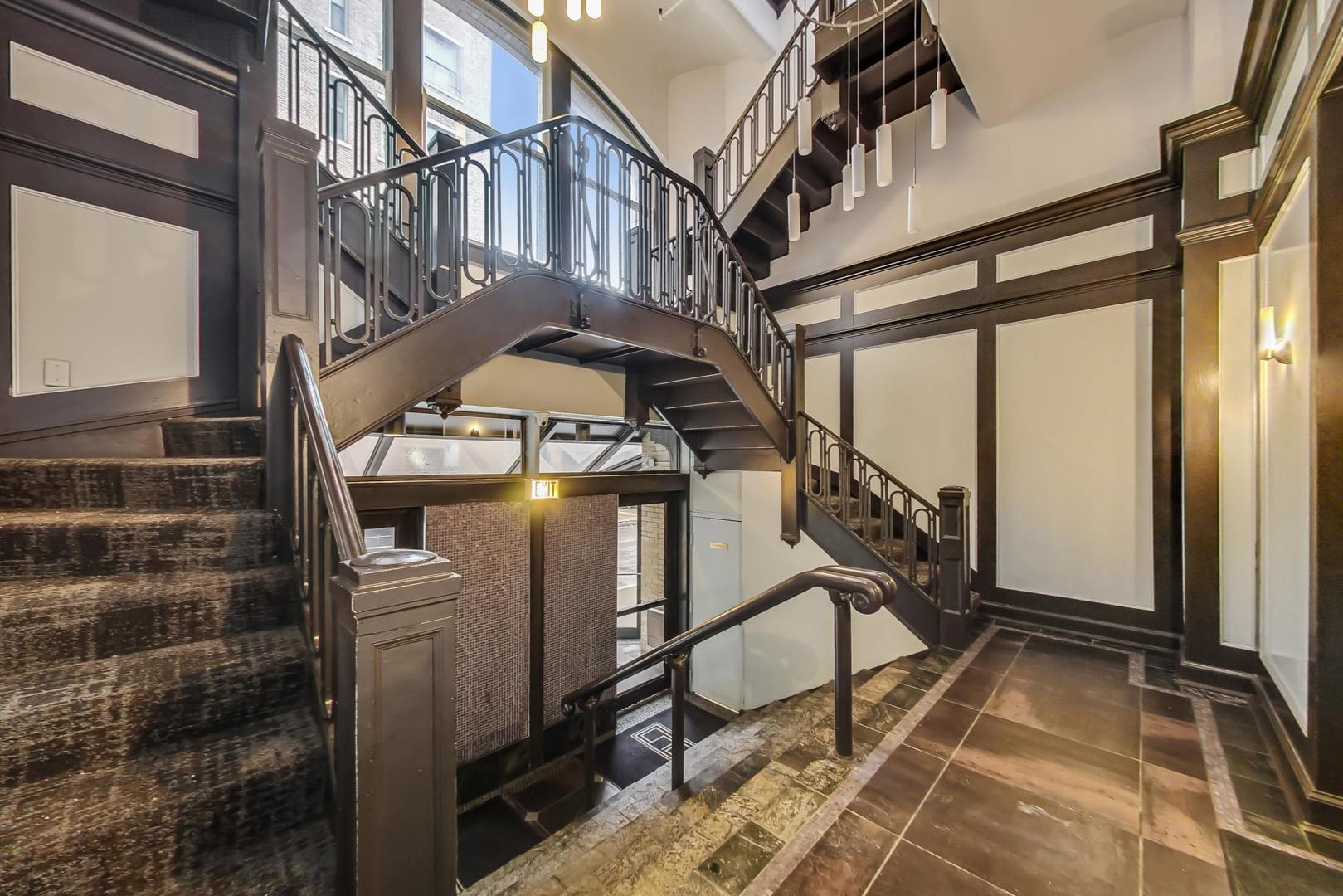 780 South Federal Street, Unit 903 Chicago, IL 60605 - Photo 9 of 31 a view of staircase with a rug