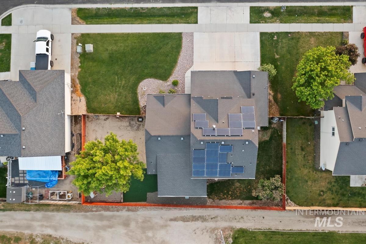 80 Cobblestone Court Middleton, ID 83644 - Photo 38 of 48 Property featuring a multi-gabled roofline, solar panel arrays, an attached garage, and a concrete driveway