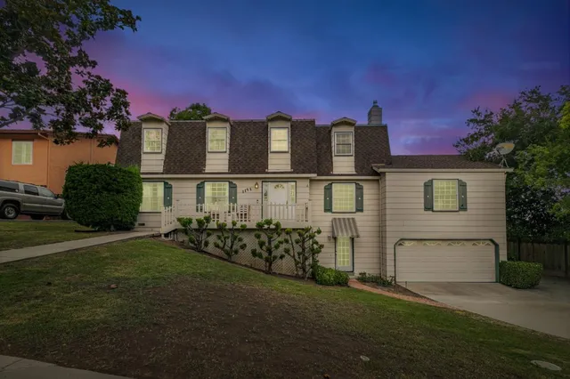 a front view of a house with a garden