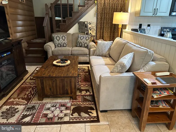 a living room with furniture and a rug