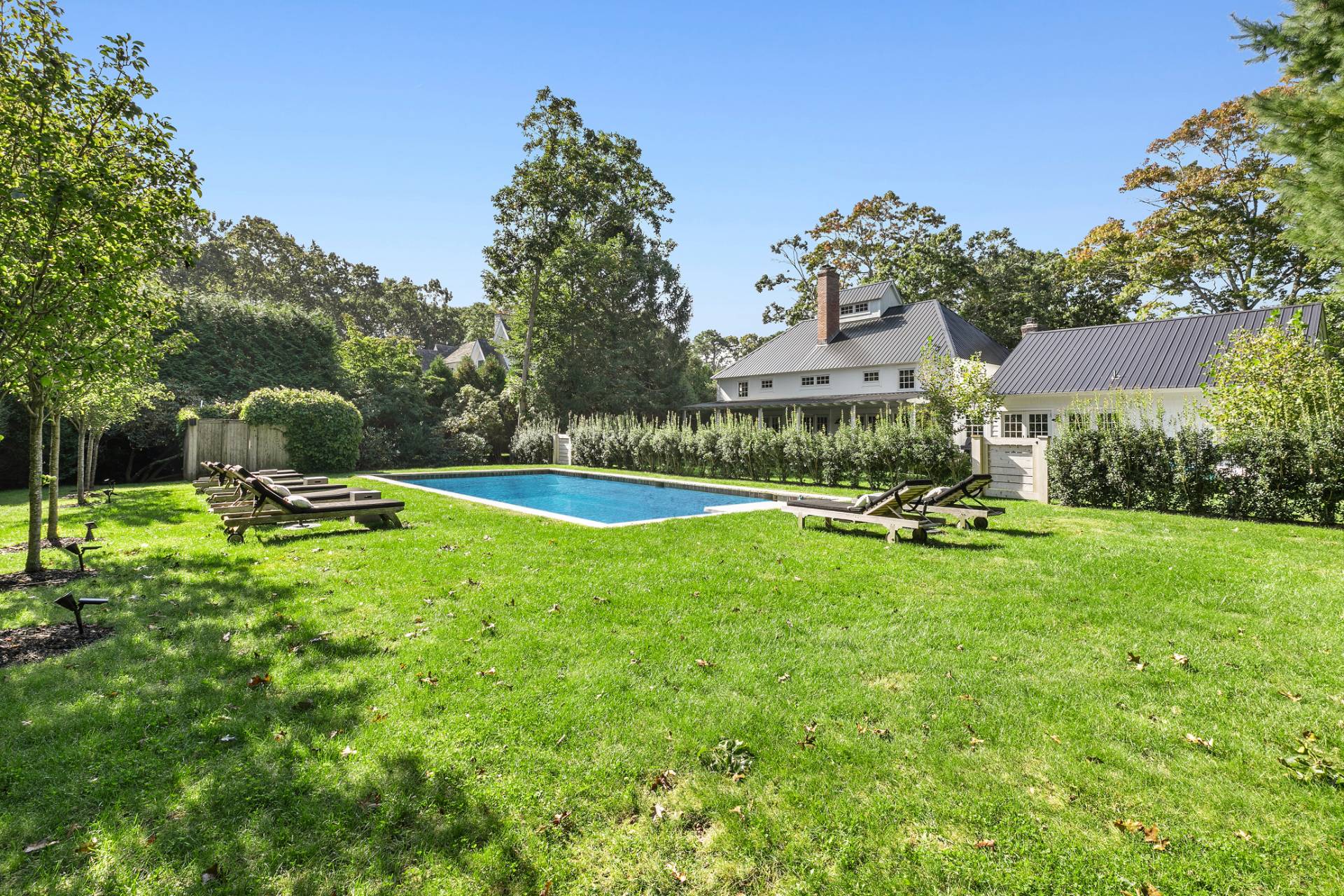 4 Lee Lane Wainscott, NY 11975 - Photo 13 of 14 a view of a garden with a bench in a garden