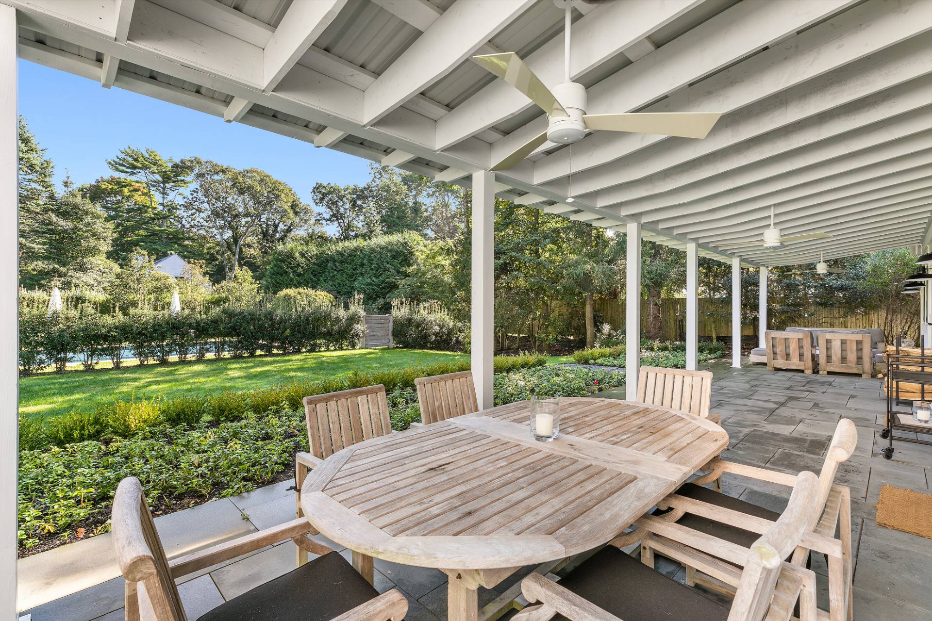 4 Lee Lane Wainscott, NY 11975 - Photo 14 of 14 a view of a patio with a table chairs and a backyard