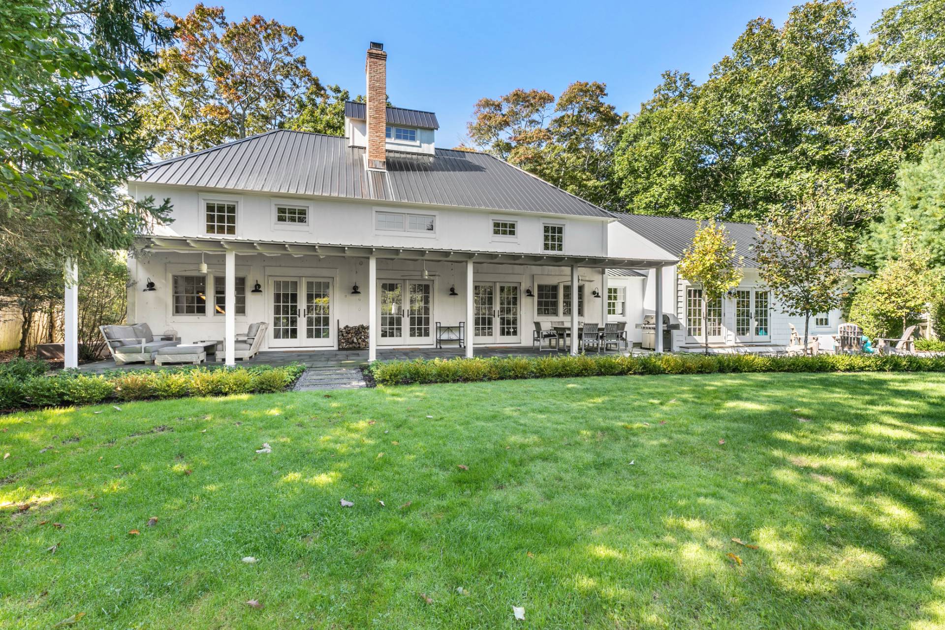 4 Lee Lane Wainscott, NY 11975 - Photo 3 of 14 a view of a house with a yard and sitting area