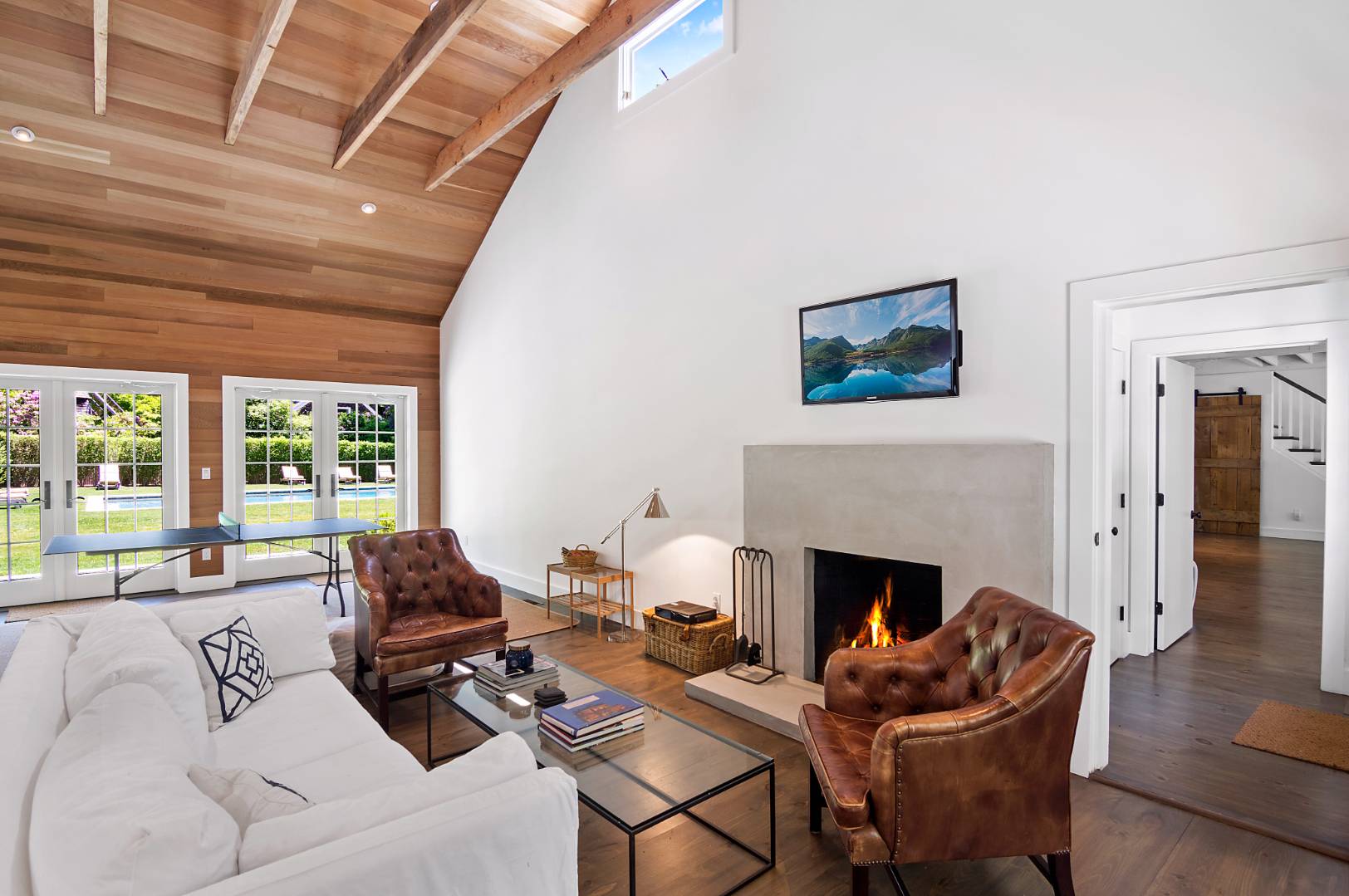 4 Lee Lane Wainscott, NY 11975 - Photo 6 of 14 a living room with furniture a fireplace and a table